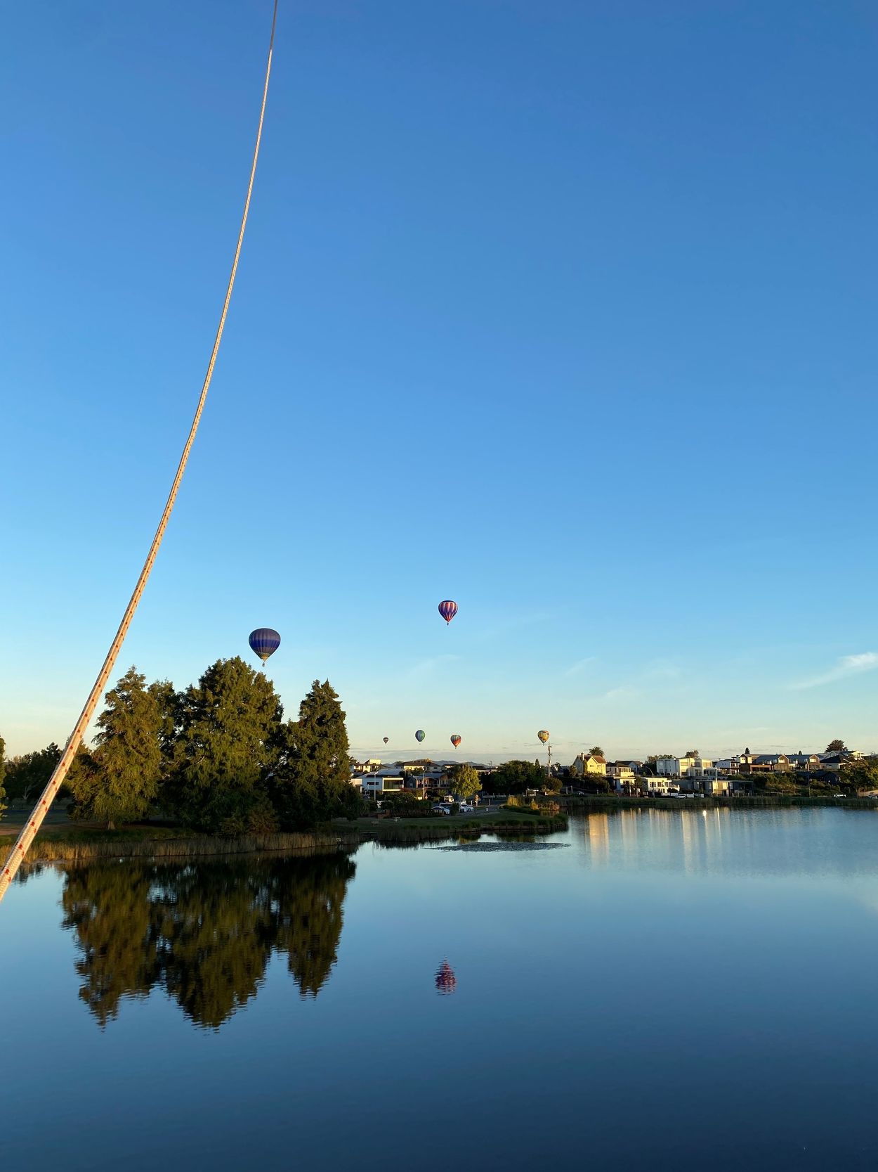 Hot air balloons over lake